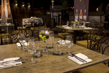 Wine glasses with napkins, glasses and gourmet food, banquet table. 