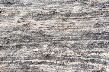 Layered metamorphic rock background texture.