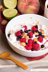 Tasty breakfast: oatmeal with yogurt and fruit on a wooden tray
