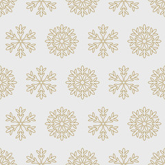 Gold snowflakes on a gray background pattern seamless