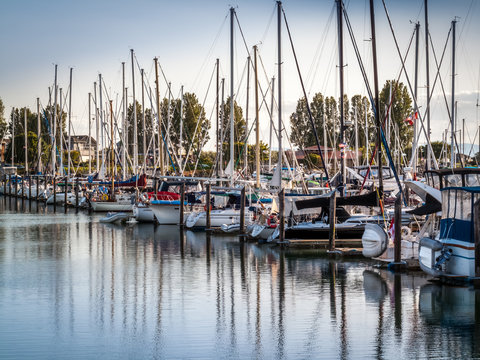 sail boats and yachts anchored in marina