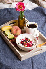 Tasty breakfast: oatmeal with yogurt and fruit on a wooden tray