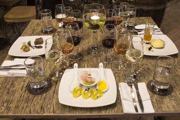 Wine glasses with napkins, glasses and gourmet food, banquet table. 