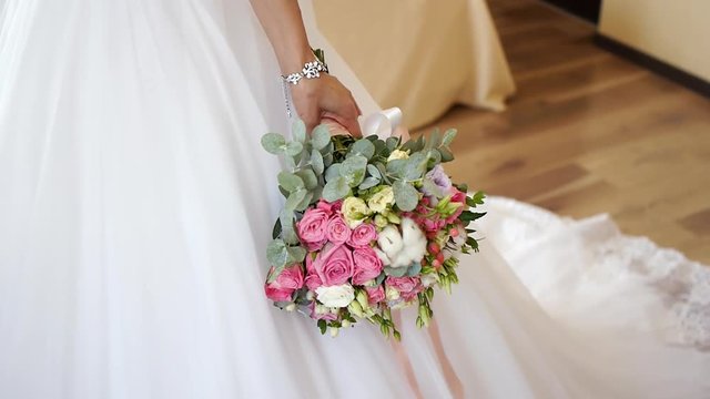 Bride holding wedding bouquet in hands