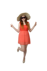 Young girl in sunglasses and in big hat poses standing on one leg isolated on vertical white background
