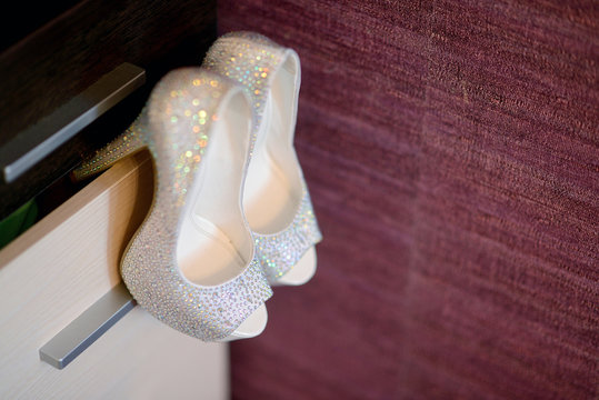 Beautiful colorful wedding shoes for bride indoors. Beauty of bridal heel for marriage. Female couple boots for celebration