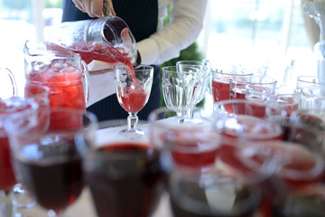 Beautiful wedding beverage for bride and groom indoors. Colorful couple glasses for alcohol. Beauty of bridal interior for marriage. Bright bar for celebration