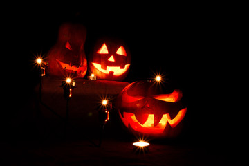 halloween three pumpkins, one on the altar and two as servants a