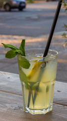 Refreshing iced mint tea with lemon and ice cubes, a drink for hot summer days selective focus, toned image