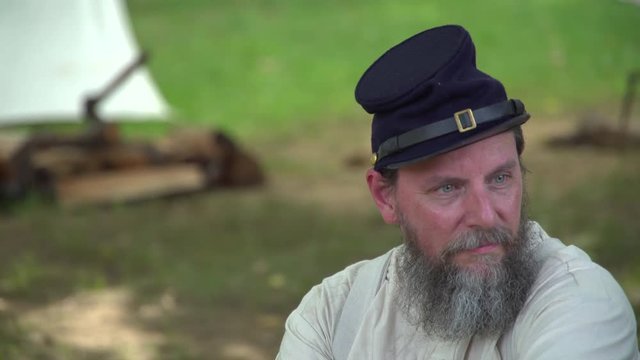 Civil War soldier sits alone in camp
