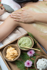 Massage series : Asian woman getting back scrub with green tea in spa