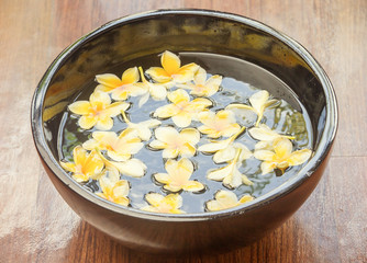 Yellow frangipani flowers floating in the spa bowl