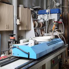 Furniture workshop interior, drilling and glue machines closeup