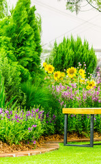 Relaxing area in cozy garden./ Wood couch in flower cozy garden. 