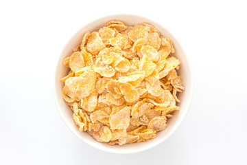 Cornflakes in a bowl, isolated on white background, Top view with copy space.