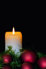 Christmas Candle with Red Baubles over Black