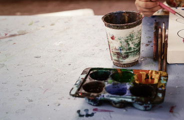 Watercolor palette with brushes