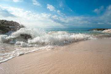 Picturesque landscape of the beach with white sand, blue sky and big rocks, Tegal Wangi beach, Bali, Indonesia. 