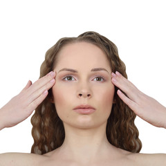 Fototapeta premium Beauty, health, make up and skin care concept - Young woman makes facial massage isolated on white background