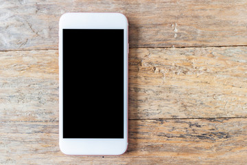 Mobile phone with blank screen mockup on wood table background,