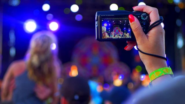 4K Woman Takes Pictures with Point and Shoot Camera, Live Music Concert Festival