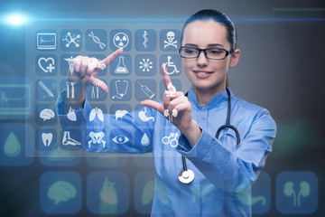 Woman doctor pressing buttons with various medical icons