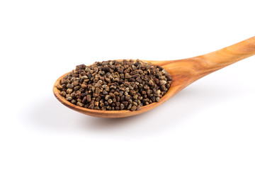 Decorticated cardamom seeds in a wooden spoon
