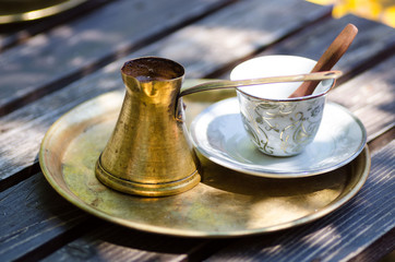 Strong and hot turkish coffee in traditional metal pot
