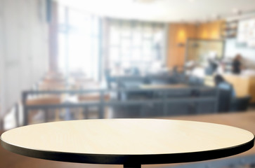 Selected focus empty brown wooden table and Coffee shop blur bac