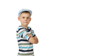 Cheeky serious boy in cap stays with hands crossed on chest and looking isolated on white background with copy space for text or advertising