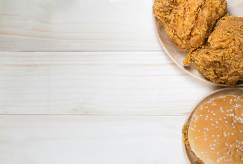 Sandwich with chicken burger on wooden plate. on top