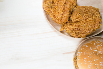 Sandwich with chicken burger on wooden plate. on top