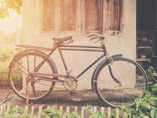 Fototapeta na wymiar Vintage bicycle or old bicycle vintage park on old wall home.