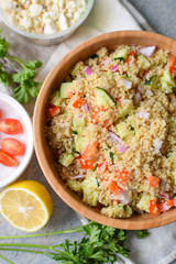 colorful quinoa party salad served in a bamboo bowl