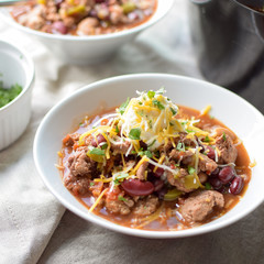 bowl of smokey turkey chili with sour cream and cheese