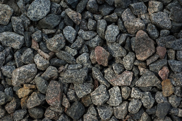 Abstract background: concrete and black granite stones.