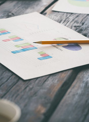 Report quarterly sales chart and pencil on the workplace