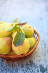 Fresh pears and half pear on the white wooden background. 