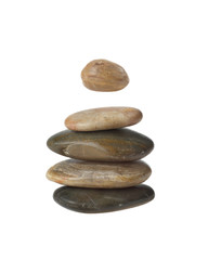 Fototapeta na wymiar Balanced zen stones in pyramid with one hanging in the air isolated on white background. Harmony and balance concept