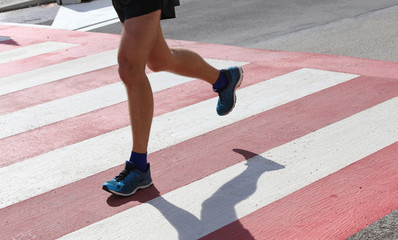 runner during the race on the Pedestrian crossing