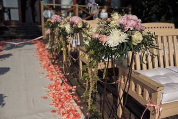 The benches with decorations for wedding ceremony