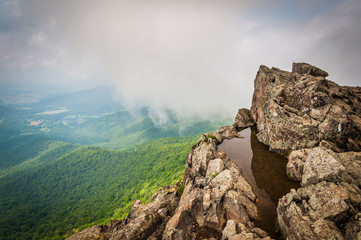 Water puddle on Little Stony Man Cliffs and foggy view of the Bl