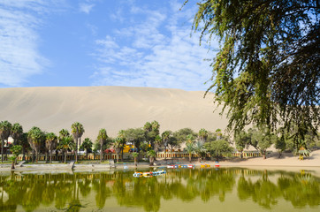 Fototapeta na wymiar Oasis- Huacachina, a village in southwestern Peru, built around a small oasis surrounded by sand dunes, Ica Region, Peru