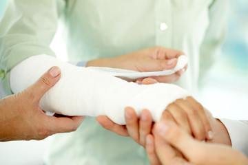 Obraz na płótnie Canvas Close-up of broken arm in plaster cast