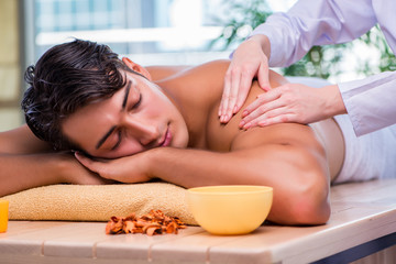 Fototapeta na wymiar Man during massage session in spa salon