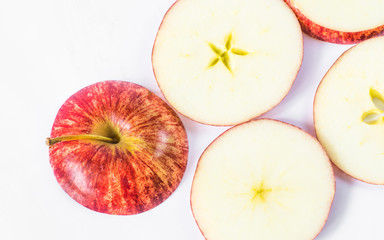 Sliced red apple placed on a white background