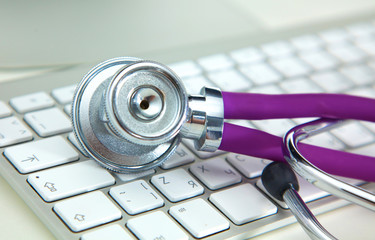 Stethoscope lying on a table an open book