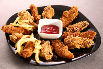 Grilled chicken on a plate standing the wooden table