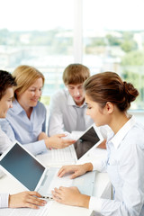 Fototapeta premium Successful business people sitting at the table and using laptop
