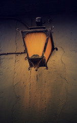 Vintage streetlight on the rustic background at the sunset. Tone